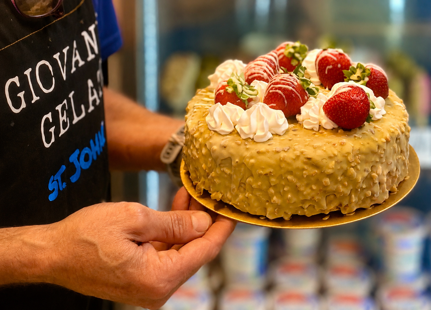 Pistachio gelato cake topped with strawberries and cream